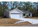 Single-story home featuring a two-car garage and a neatly landscaped front yard at 20 Malauka Pass Crse, Ocklawaha, FL 32179