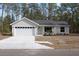 Charming single-story home featuring a two-car garage and a neatly landscaped front yard at 20 Malauka Pass Crse, Ocklawaha, FL 32179