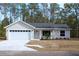 Charming single-story home featuring a two-car garage and a neatly landscaped front yard at 20 Malauka Pass Crse, Ocklawaha, FL 32179