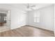 Bedroom with wood-look floors, closet, window, and ceiling fan at 2087 Bonneau Ln, The Villages, FL 32162