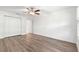 Bedroom with wood-look floors, closet, and ceiling fan at 2087 Bonneau Ln, The Villages, FL 32162