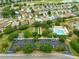 A community pool area with ample parking, lush trees, and greenery, providing a relaxing outdoor retreat at 2087 Bonneau Ln, The Villages, FL 32162