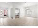 Open dining room with tile flooring, plantation shutters, and an arched entryway to the kitchen at 2087 Bonneau Ln, The Villages, FL 32162