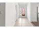Inviting foyer with tile flooring, a decorative glass front door, and white interior doors at 2087 Bonneau Ln, The Villages, FL 32162