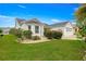 Charming single-story home with meticulously maintained lawn, flowering shrubs, and a two-car garage at 2087 Bonneau Ln, The Villages, FL 32162