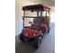 Burgundy golf cart with customized Redskins decor offers a fun way to explore the community at 2087 Bonneau Ln, The Villages, FL 32162