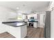 Modern kitchen showcasing white cabinetry, stainless steel appliances, and a cozy breakfast nook at 2087 Bonneau Ln, The Villages, FL 32162