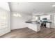 Eat-in kitchen featuring white cabinets, dark countertops, and a modern appliance package at 2087 Bonneau Ln, The Villages, FL 32162