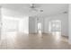 Bright living room featuring neutral tile flooring, ceiling fan, and views to the front and back of the home at 2087 Bonneau Ln, The Villages, FL 32162
