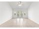 Bright living room with tile flooring and French doors to the outside at 2087 Bonneau Ln, The Villages, FL 32162