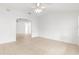 Open-concept living room with tile flooring, ceiling fan, and bright lighting at 2087 Bonneau Ln, The Villages, FL 32162