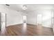 Spacious main bedroom with wood-look floors, ensuite bathroom, and walk-in closet at 2087 Bonneau Ln, The Villages, FL 32162