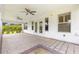Covered outdoor patio with brick pavers and ceiling fans, perfect for entertaining or relaxing in the backyard at 2087 Bonneau Ln, The Villages, FL 32162