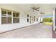 Covered patio with brick pavers, ceiling fans, and access to a screened-in area at 2087 Bonneau Ln, The Villages, FL 32162