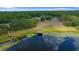 Scenic aerial view of community area with beautiful lake access and serene, green surroundings at 21168 Sw Peach Blossom St, Dunnellon, FL 34431