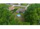 Aerial view of a home with an above ground pool surrounded by lush green trees at 21168 Sw Peach Blossom St, Dunnellon, FL 34431