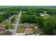 Aerial view of a residential area featuring a house with a backyard pool, shed, and green lawn at 21168 Sw Peach Blossom St, Dunnellon, FL 34431