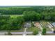 Aerial view of property featuring a backyard pool, shed, green lawn, and surrounded by trees at 21168 Sw Peach Blossom St, Dunnellon, FL 34431