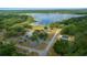 Beautiful aerial view of community area with lake, parking, community building, and playground at 21168 Sw Peach Blossom St, Dunnellon, FL 34431