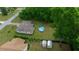 An aerial view of a home with a backyard, pool, and additional storage structures at 21168 Sw Peach Blossom St, Dunnellon, FL 34431