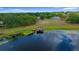 Gorgeous aerial view of lakefront property with mature trees and a dock for serene waterfront living at 21168 Sw Peach Blossom St, Dunnellon, FL 34431