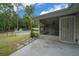 View of a screened porch, above ground pool, and wooded lot creating a private backyard at 21168 Sw Peach Blossom St, Dunnellon, FL 34431