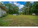 Expansive backyard offering ample space for recreation and relaxation with mature trees at 21168 Sw Peach Blossom St, Dunnellon, FL 34431