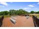 A spacious wooden deck featuring built-in benches, perfect for enjoying outdoor gatherings and panoramic views at 21168 Sw Peach Blossom St, Dunnellon, FL 34431