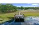 A lovely aerial view of the dock with a beautiful waterfront and green surroundings at 21168 Sw Peach Blossom St, Dunnellon, FL 34431