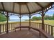 Interior view of a gazebo with built-in wooden benches, perfect for enjoying peaceful moments by the lake at 21168 Sw Peach Blossom St, Dunnellon, FL 34431