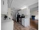 Galley kitchen featuring white cabinetry, stainless steel appliances, and neutral countertops at 21168 Sw Peach Blossom St, Dunnellon, FL 34431
