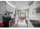 Eat-in kitchen featuring white cabinets, a black range, and a bay window with seating at 21168 Sw Peach Blossom St, Dunnellon, FL 34431