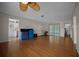 Large living area with laminate flooring, a ceiling fan, and sliding doors to screened porch at 21168 Sw Peach Blossom St, Dunnellon, FL 34431