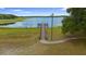 Scenic view of the lake featuring a wooden pier, ideal for fishing or enjoying lakeside views at 21168 Sw Peach Blossom St, Dunnellon, FL 34431