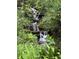Beautiful water feature nestled amongst lush, mature landscaping at 21168 Sw Peach Blossom St, Dunnellon, FL 34431