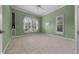 Spacious bedroom featuring carpeted floors, built-in shelving, and large windows for ample natural light at 2146 Se 25Th Loop, Ocala, FL 34471