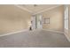 Spacious bedroom with neutral carpet, ceiling fan, and walk-in closet at 2146 Se 25Th Loop, Ocala, FL 34471