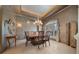Formal dining area with elegant chandelier, decorative walls, and a large window with custom draperies at 2146 Se 25Th Loop, Ocala, FL 34471