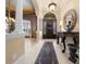 Grand foyer with a decorative mirror, tile flooring, soaring columns, and a beautiful front door at 2146 Se 25Th Loop, Ocala, FL 34471