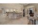Open kitchen with breakfast bar, pendant lighting, and a view to the entry hall at 2146 Se 25Th Loop, Ocala, FL 34471