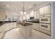 Spacious kitchen featuring an island with granite countertops, custom cabinets, and stainless steel appliances at 2146 Se 25Th Loop, Ocala, FL 34471