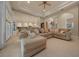 Spacious living room featuring a comfortable oversized sectional sofa and light-filled open-concept design at 2146 Se 25Th Loop, Ocala, FL 34471