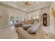 Comfortable living room with a large sofa, tray ceiling, and access to an outdoor patio, perfect for relaxation at 2146 Se 25Th Loop, Ocala, FL 34471