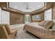 Large main bedroom featuring a king bed, sitting area, and neutral carpet at 2146 Se 25Th Loop, Ocala, FL 34471