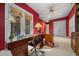 Vibrant home office with a large desk, built-in storage, and a window providing natural light at 2146 Se 25Th Loop, Ocala, FL 34471