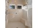Modern tiled shower featuring dual showerheads, built-in bench, and dual transom windows at 2146 Se 25Th Loop, Ocala, FL 34471