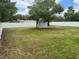 The spacious backyard is enclosed with a white privacy fence and has mature trees at 21570 Sw Raintree St, Dunnellon, FL 34431