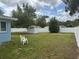This large backyard features a shed, chairs and a white privacy fence at 21570 Sw Raintree St, Dunnellon, FL 34431