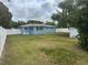 The backyard features a white privacy fence, mature trees and a small shed at 21570 Sw Raintree St, Dunnellon, FL 34431