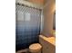 This bathroom features a geometric shower curtain and a white vanity with sink and faucet at 21570 Sw Raintree St, Dunnellon, FL 34431